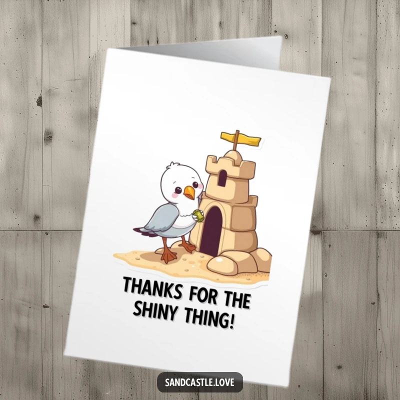 Funny Free Printable Thank You Card: A mischievous seagull clutches a stolen shiny object near a sandcastle.