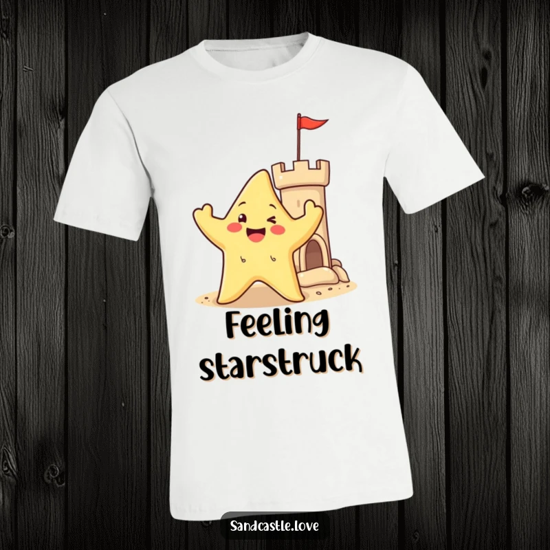 T-shirt featuring a happy starfish character waving its arms near a sandy castle turret, radiating joy and beachside celebration.